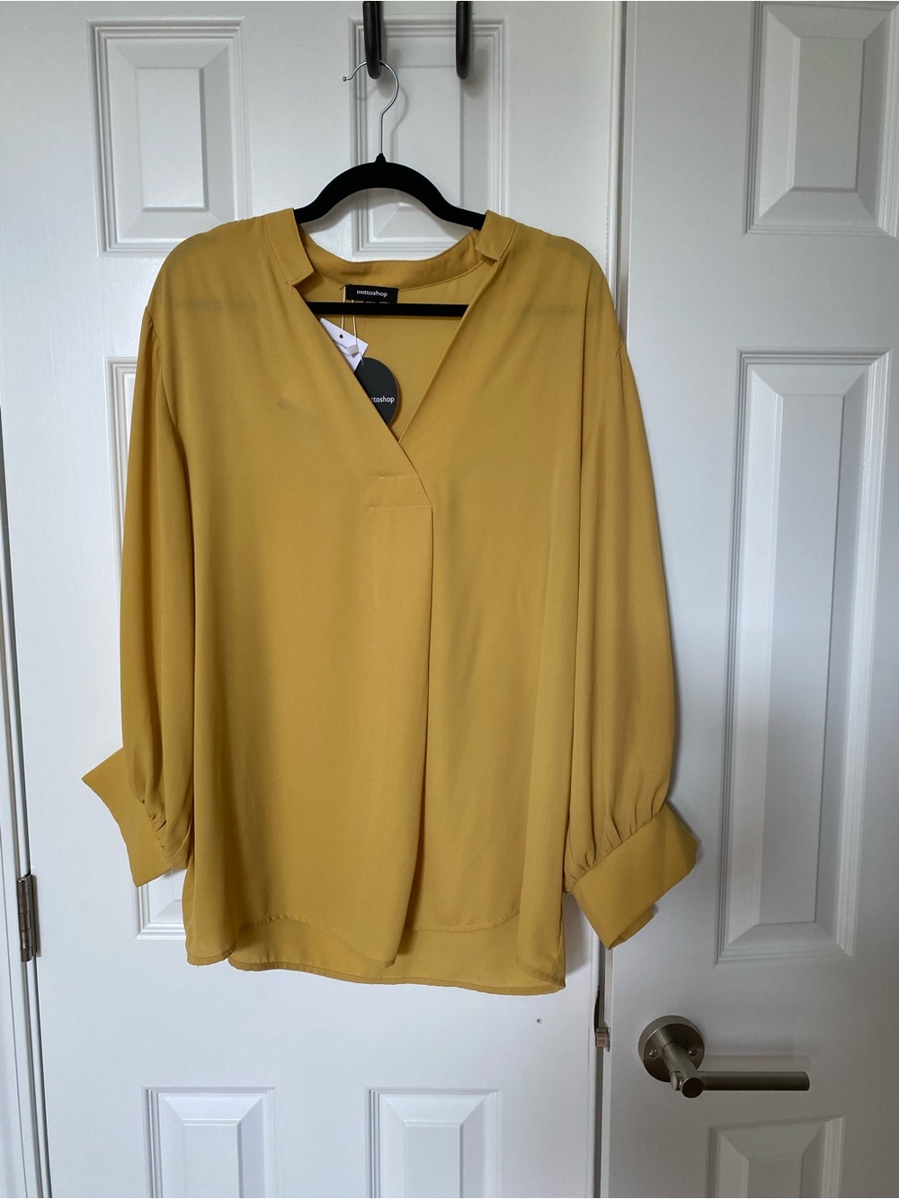 Gold colored women’s blouse with front pleat. NWT size L